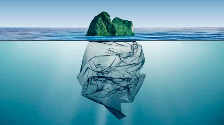 garbage plastic with island floating in the ocean.