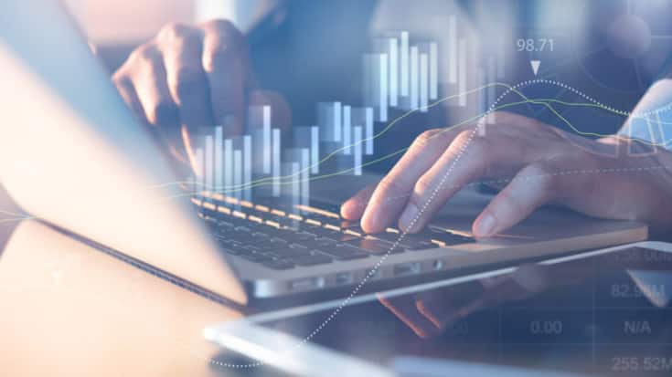 Business analysis concept. Businessman analyzing business data, stock market report on laptop computer in office with financial graph on virtual screen