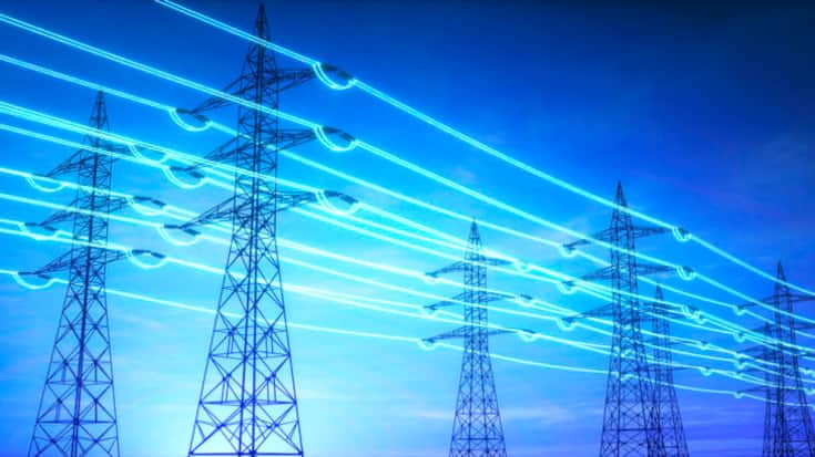 High voltage transmission towers with glowing wires against blue sky - Energy concept