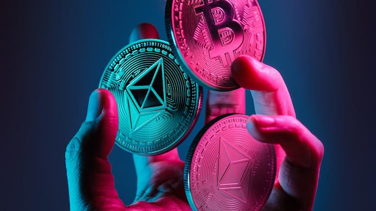 Ethereum,And,Bitcoin,Tokens,Floating,Over,A,Hand,With,Blue
