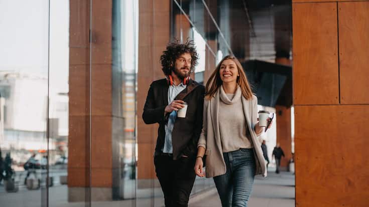 Business,Man,And,Business,Woman,Talking,And,Holding,Luggage,Traveling