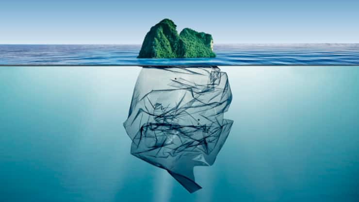 garbage plastic with island floating in the ocean.