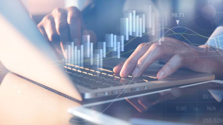 Business analysis concept. Businessman analyzing business data, stock market report on laptop computer in office with financial graph on virtual screen