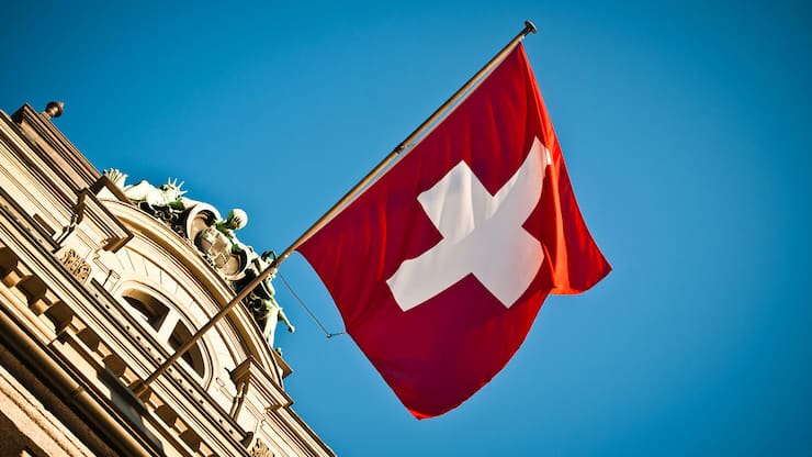 swiss flag waving on historic building