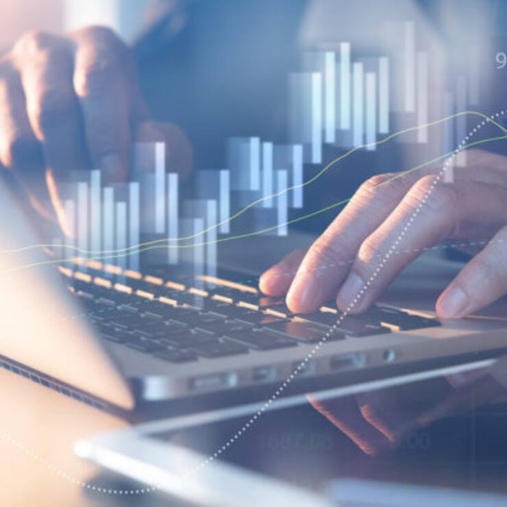 Business analysis concept. Businessman analyzing business data, stock market report on laptop computer in office with financial graph on virtual screen
