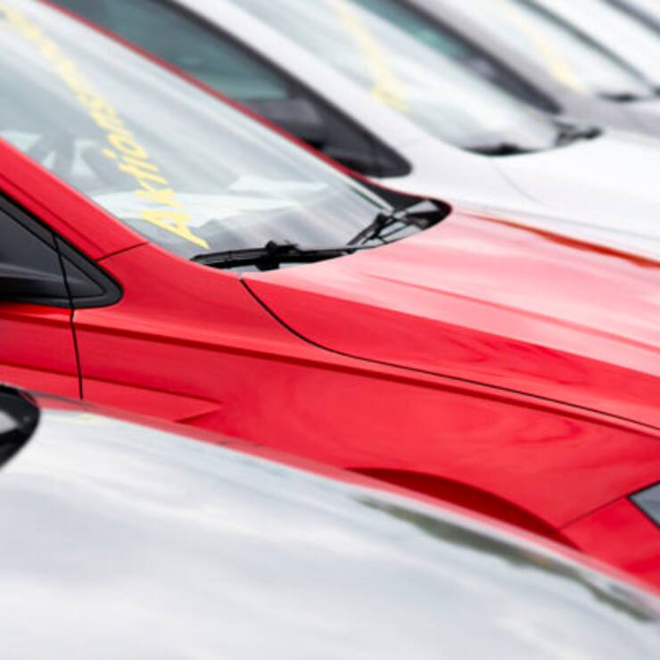 Hamburg, Germany - August 8, 2021: A number of used vehicles parked at a public car dealer.  A red vehicle stands out in particular, in Hamburg, Germany