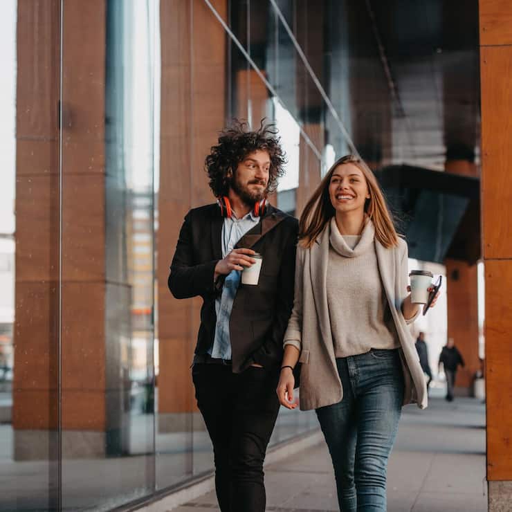 Business,Man,And,Business,Woman,Talking,And,Holding,Luggage,Traveling